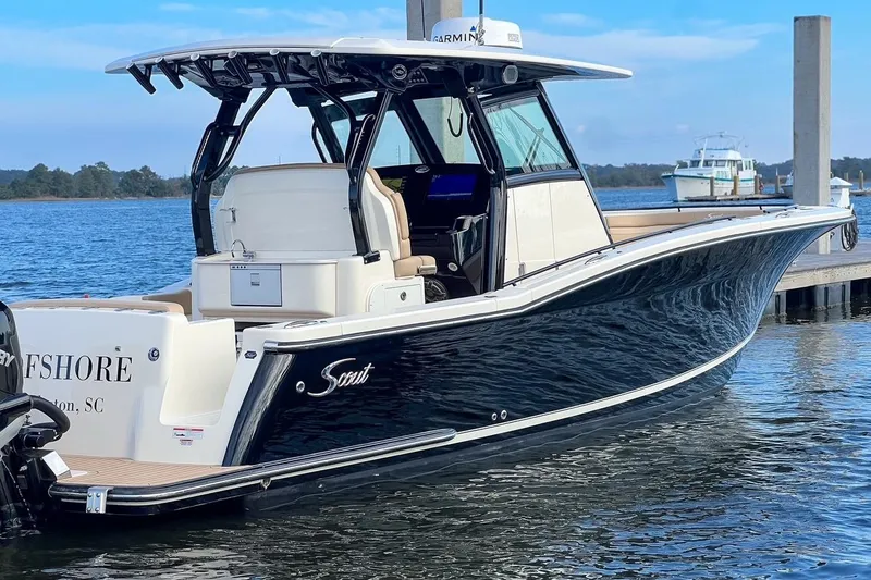 Slide: The Image of 2022 Scout 330 LXF boat docked on calm water, featuring sleek design and modern amenities. - 72