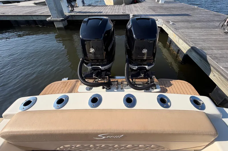 Slide: The Image of 2022 Scout 330 LXF boat with twin outboard engines at dock. - 75
