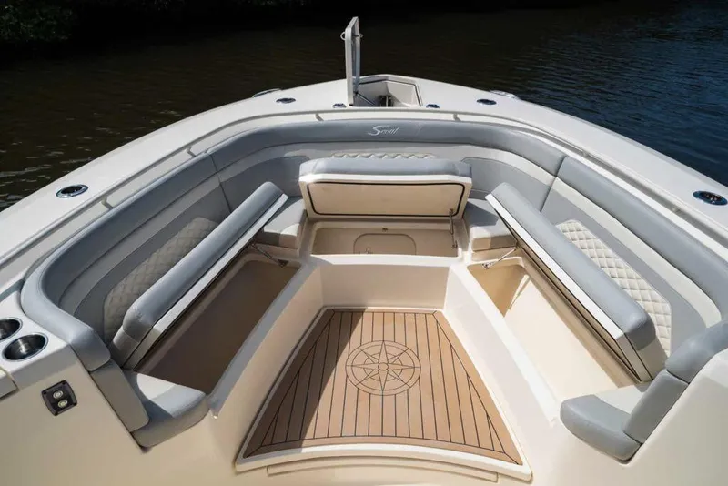 Slide: The Image of Manufacturer Provided Image: 2022 Scout 330 LXF boat interior with cushioned seating and teak flooring. - 85