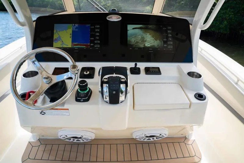 Slide: The Image of Manufacturer Provided Image: 2022 Scout 330 LXF boat dashboard with navigation screens and controls. - 88
