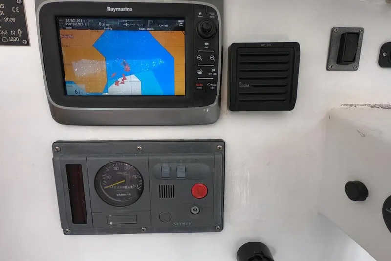 Slide: The Image of Control panel of a 2006 Maxim Yachts 57 with navigation display and gauges. - 14