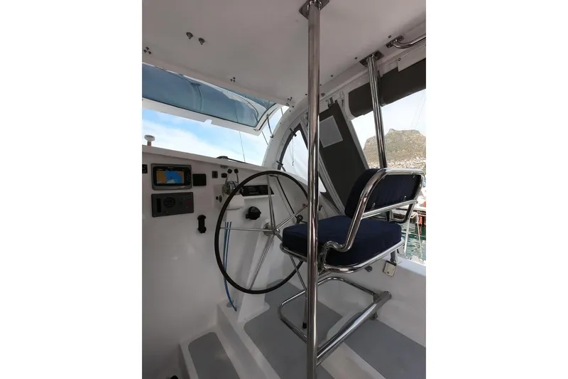 Slide: The Image of Helm station of 2006 Maxim Yachts 57, featuring steering wheel and navigation equipment. - 15