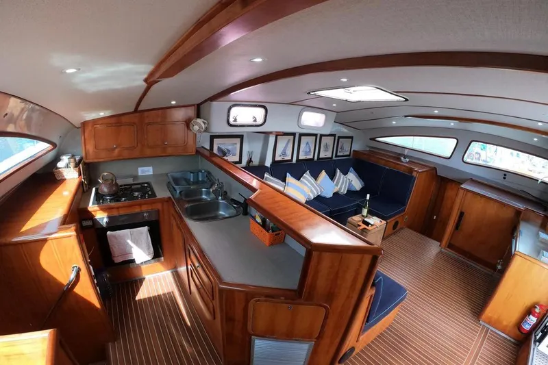 Slide: The Image of Luxurious 2006 Maxim Yachts 57 interior with elegant wood finish and cozy seating area. - 16