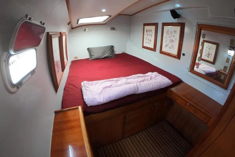 Slide: The Image of Cozy cabin interior of 2006 Maxim Yachts 57 with red bedding and wooden accents. - 24