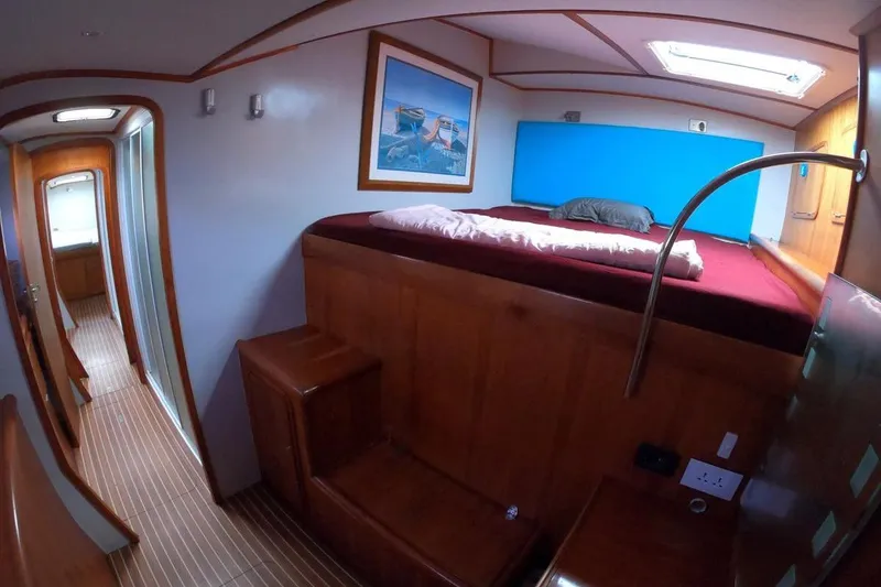 Slide: The Image of Luxurious cabin interior of 2006 Maxim Yachts 57 with wooden finish and cozy bed. - 26