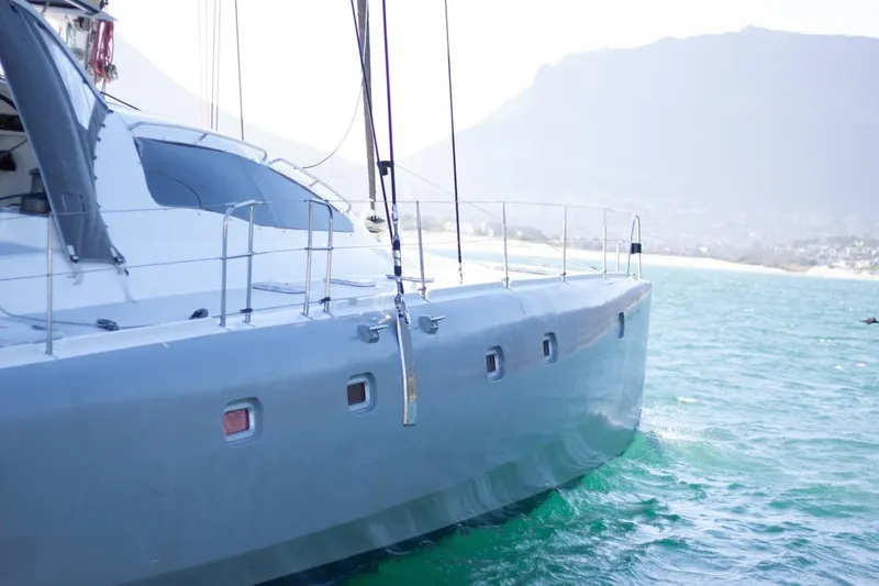 Slide: The Image of 2006 Maxim Yachts 57 sailing on turquoise waters with mountainous backdrop. - 31