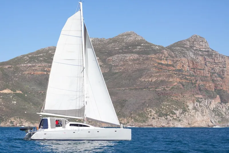 Slide: The Image of Sailing yacht Maxim Yachts 57, 2006 model, cruising near rocky coastline. - 35