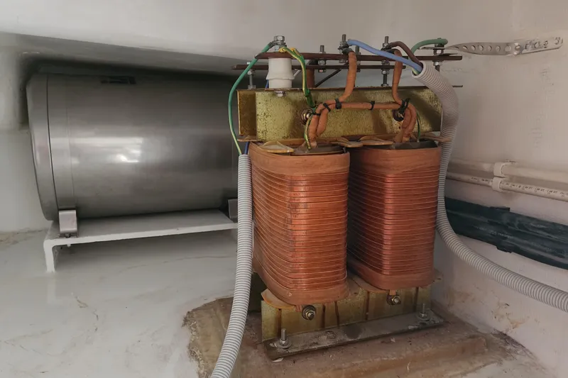 Slide: The Image of Electrical components inside a 2006 Maxim Yachts 57, featuring copper coils and wiring. - 39