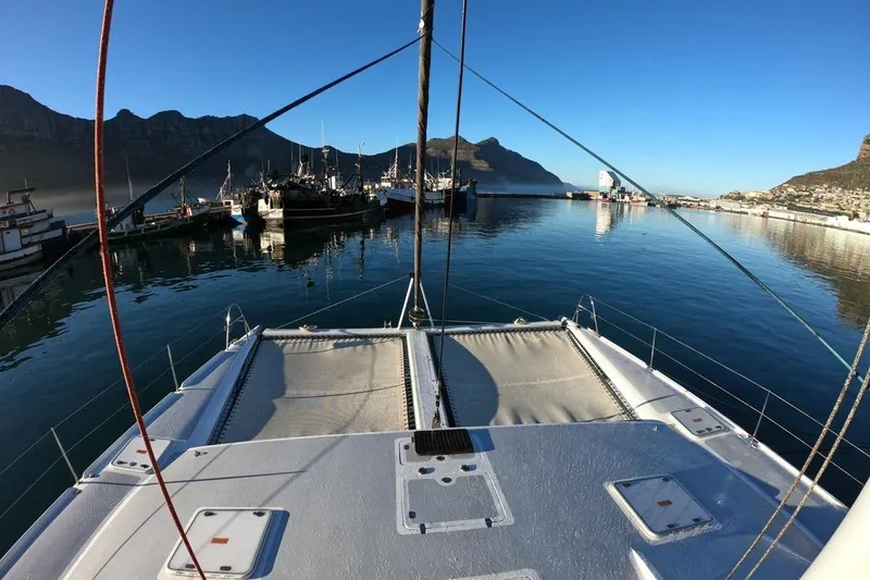 Slide: The Image of 2006 Maxim Yachts 57 docked in a scenic harbor with mountains. - 4