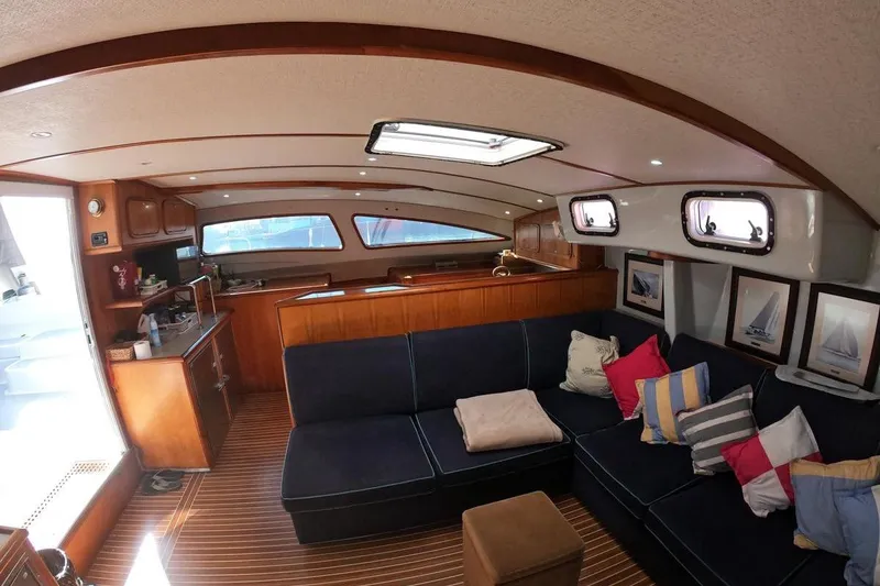 Slide: The Image of Interior of 2006 Maxim Yachts 57, featuring cozy seating and elegant wood finishes. - 6