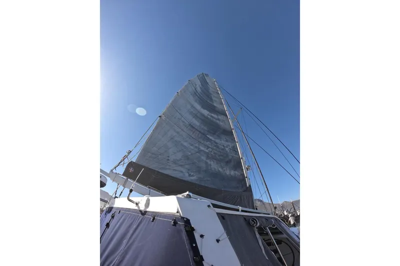 Slide: The Image of Sail of a 2006 Maxim Yachts 57 against a clear blue sky. - 7
