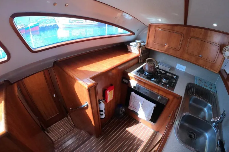 Slide: The Image of Luxurious 2006 Maxim Yachts 57 kitchen with wooden cabinetry and modern appliances. - 17