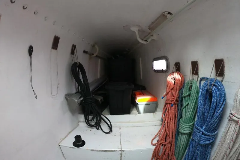 Slide: The Image of Storage area inside a 2006 Maxim Yachts 57, featuring ropes and equipment. - 21