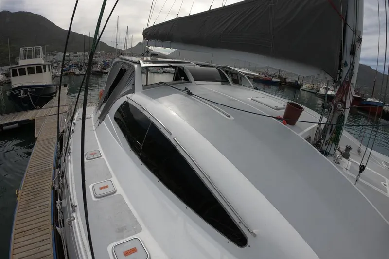 Slide: The Image of 2006 Maxim Yachts 57 docked in a marina, showcasing sleek design and spacious deck. - 23