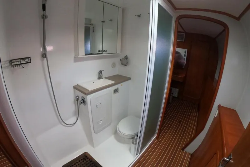 Slide: The Image of Bathroom interior of 2006 Maxim Yachts 57, featuring shower, sink, and toilet. - 25