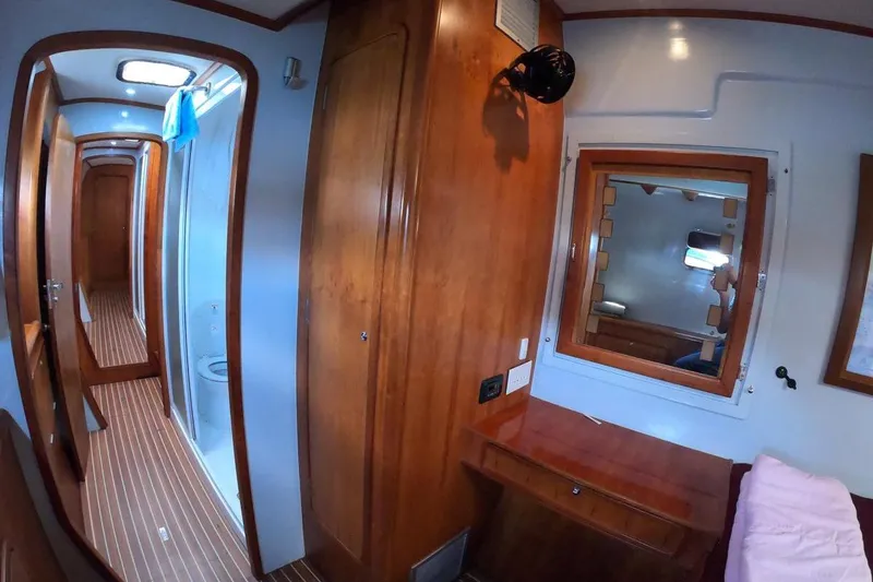 Slide: The Image of Interior of 2006 Maxim Yachts 57, featuring wood paneling and a compact bathroom. - 29