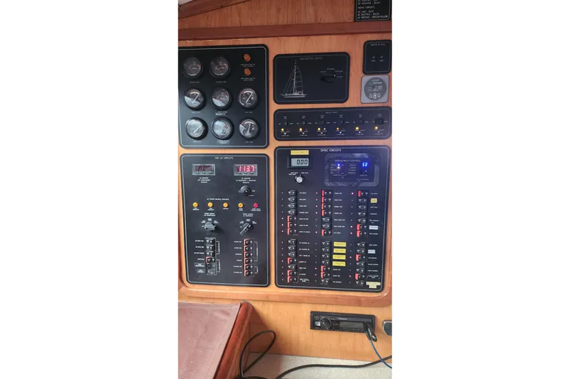 Slide: The Image of Control panel of a 2006 Maxim Yachts 57, featuring gauges and circuit switches. - 44