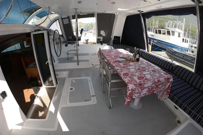 Slide: The Image of Spacious 2006 Maxim Yachts 57 interior with dining area and helm, docked at marina. - 9