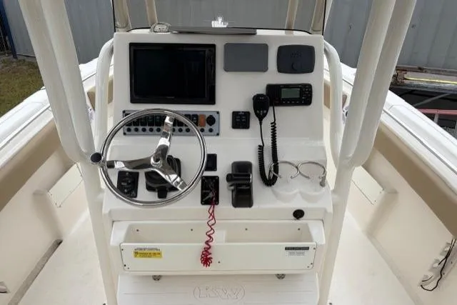 Slide: The Image of 2018 Key West 239 FS boat console with steering wheel and navigation equipment. - 15