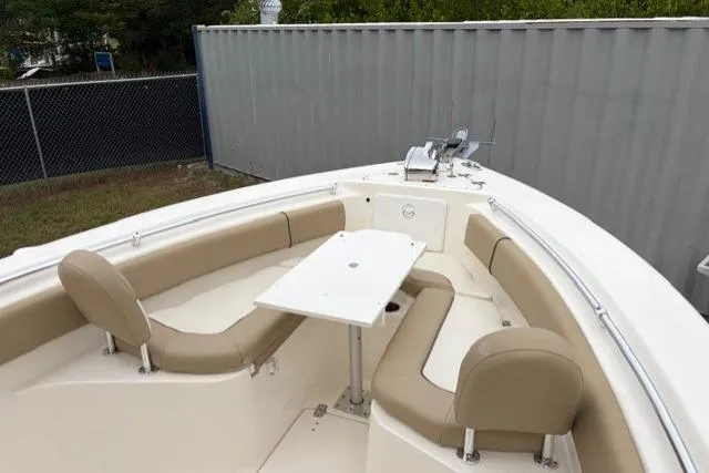 Slide: The Image of 2018 Key West 239 FS boat with beige seating and a central table. - 21