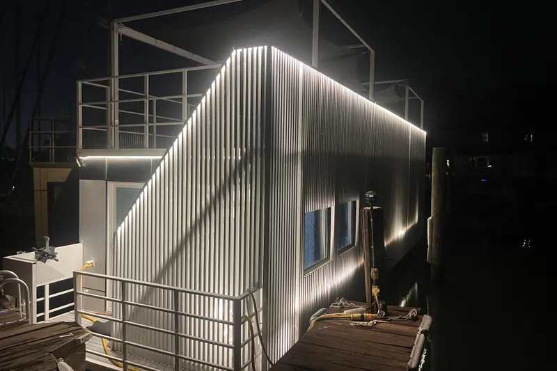 The Image of Modern Struktures MS400 houseboat illuminated at night, showcasing sleek design and contemporary architecture. - 0