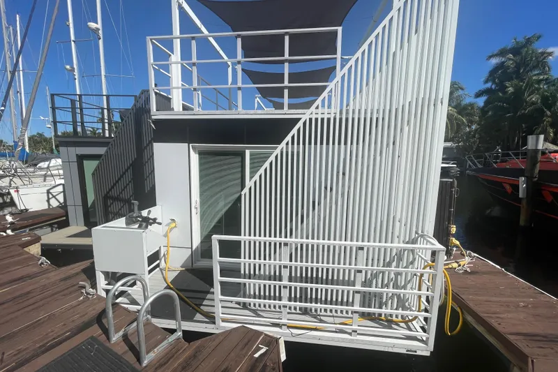 Slide: The Image of Modern Struktures MS400 houseboat with rooftop deck and dockside view, 2023 model. - 1