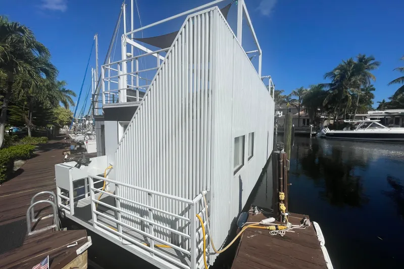 Slide: The Image of Modern Struktures MS400 houseboat docked by palm trees, 2023 model. - 4