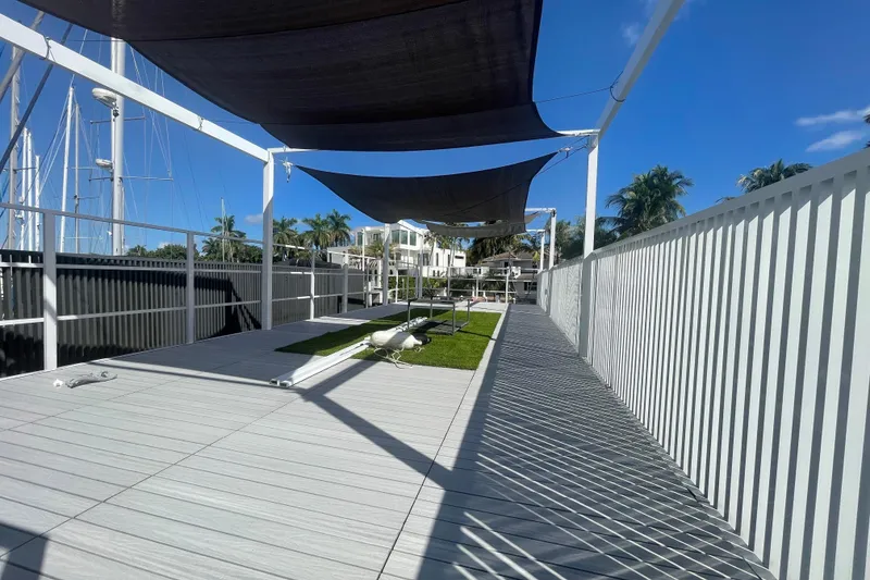 Slide: The Image of Modern Struktures MS400 deck with shade sails, 2023 model, featuring sleek design and palm trees. - 8