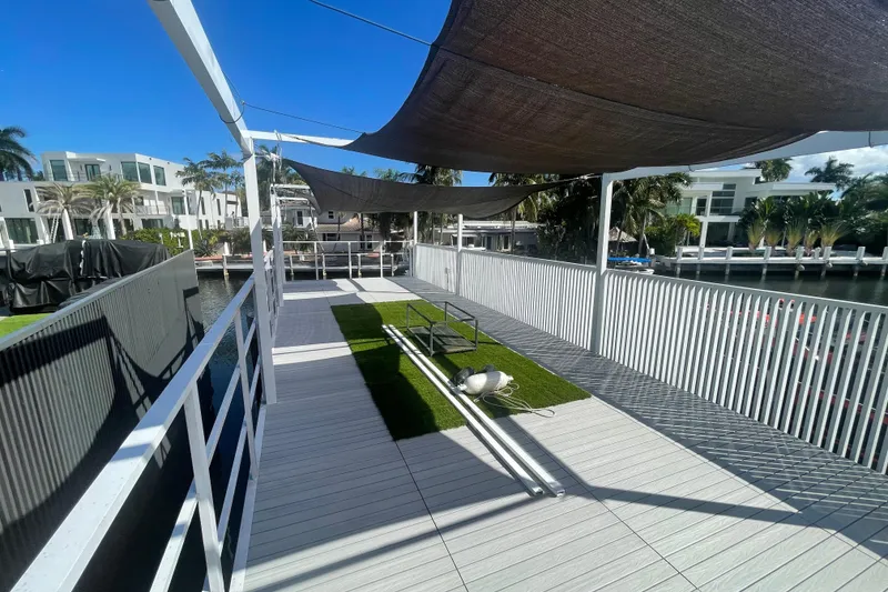 Slide: The Image of Modern Struktures MS400 deck with shade sails, overlooking waterfront, 2023 design. - 9