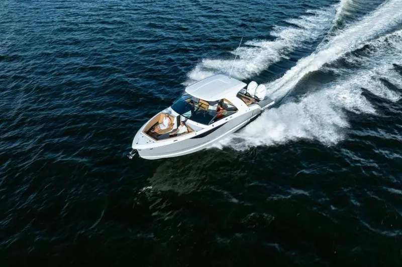 Slide: The Image of 2026 Four Winns H33 cabin interior with wood finish and seating area. - 10