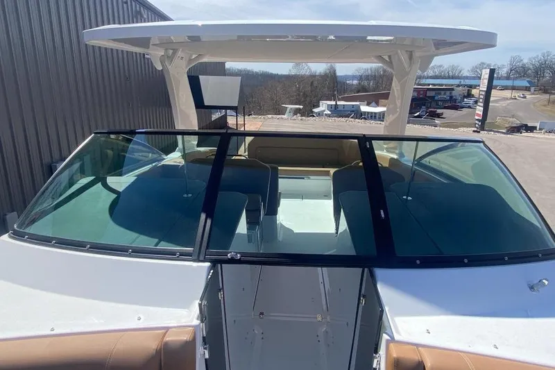 Slide: The Image of 2026 Four Winns H33 boat with sleek windshield and spacious seating area. - 18