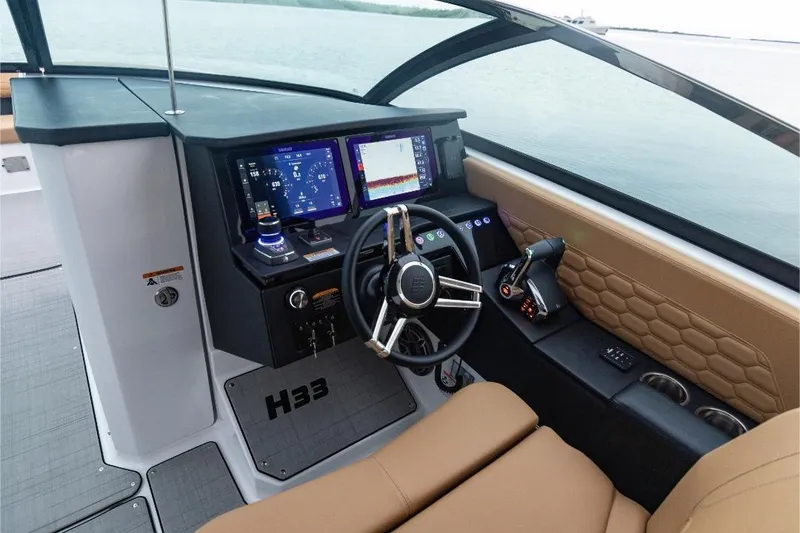 Slide: The Image of 2026 Four Winns H33 boat showcased indoors with modern design and lighting. - 2