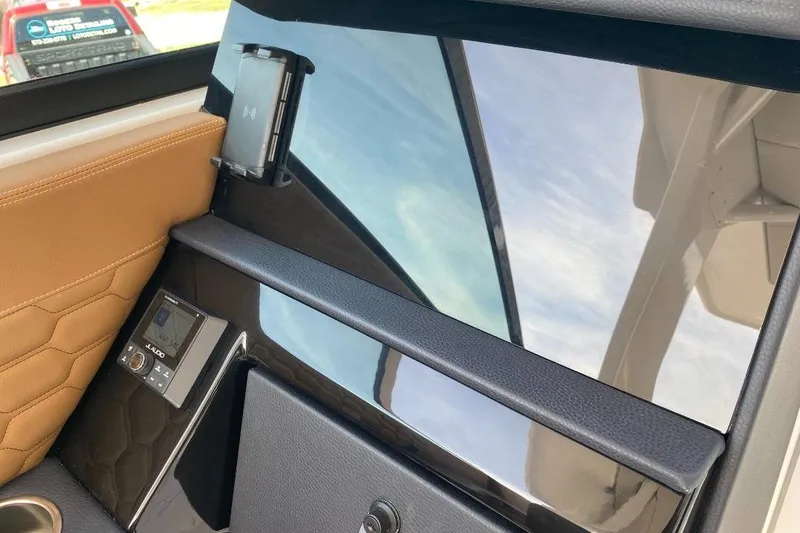 Slide: The Image of Interior of 2026 Four Winns H33 boat with sleek design and modern controls. - 25