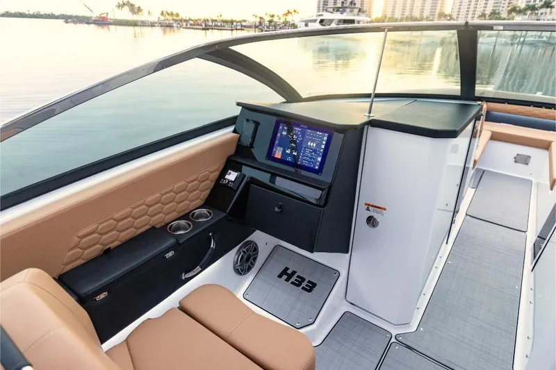 Slide: The Image of 2026 Four Winns H33 luxury boat displayed at an indoor exhibition, showcasing sleek design. - 3