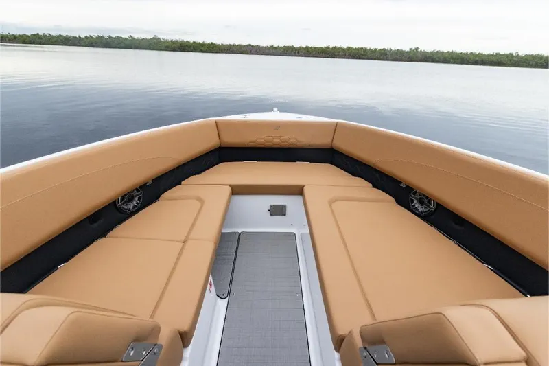 Slide: The Image of Interior of 2026 Four Winns H33 boat with modern dashboard and tan seating. - 6
