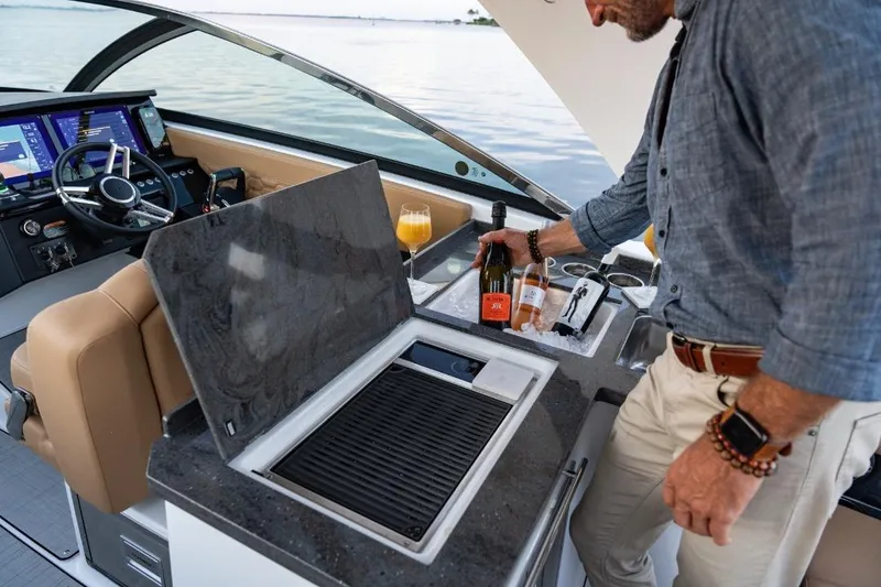 Slide: The Image of 2026 Four Winns H33 boat cockpit with modern controls and luxurious seating. - 7