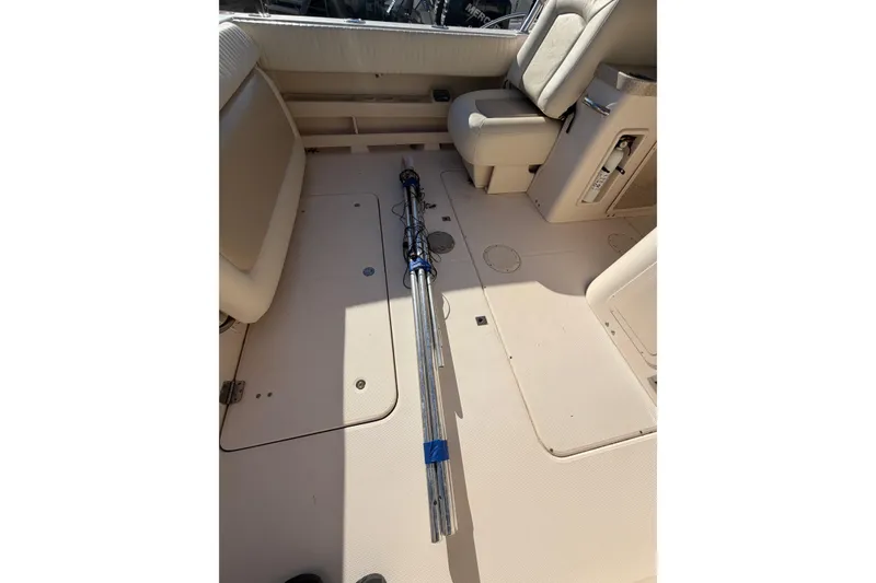 Slide: The Image of 2009 Grady-White Tournament 307 boat interior with fishing rods on deck. - 12