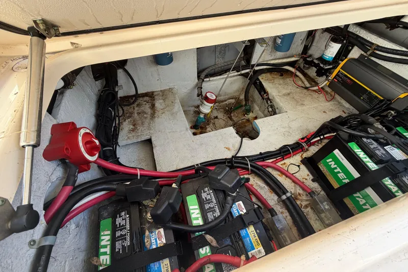 Slide: The Image of 2009 Grady-White Tournament 307 boat battery compartment with wiring and equipment. - 13