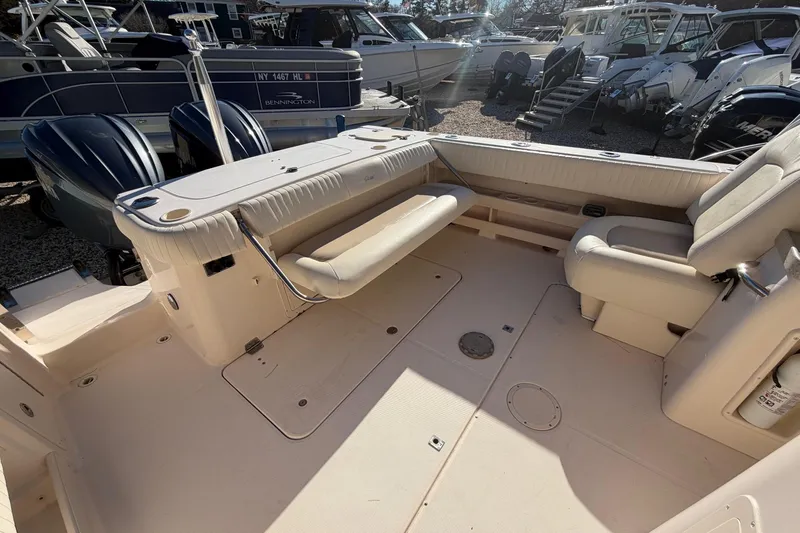 Slide: The Image of 2009 Grady-White Tournament 307 boat interior with seating and dual outboard engines. - 14