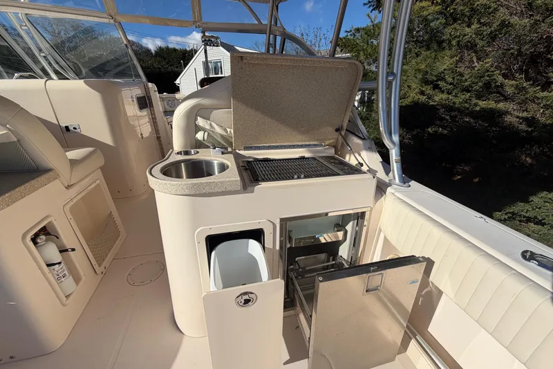 Slide: The Image of 2009 Grady-White Tournament 307 boat interior with kitchenette and seating area. - 19