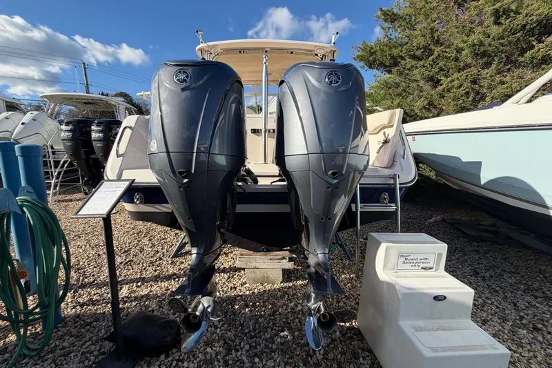 Slide: The Image of 2009 Grady-White Tournament 307 boat with dual outboard engines, displayed outdoors. - 2