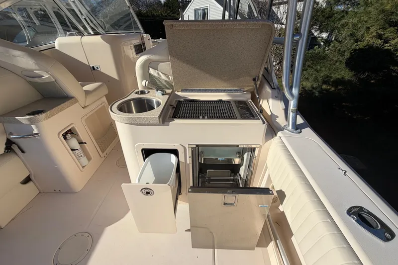 Slide: The Image of 2009 Grady-White Tournament 307 boat interior with kitchenette and seating area. - 20