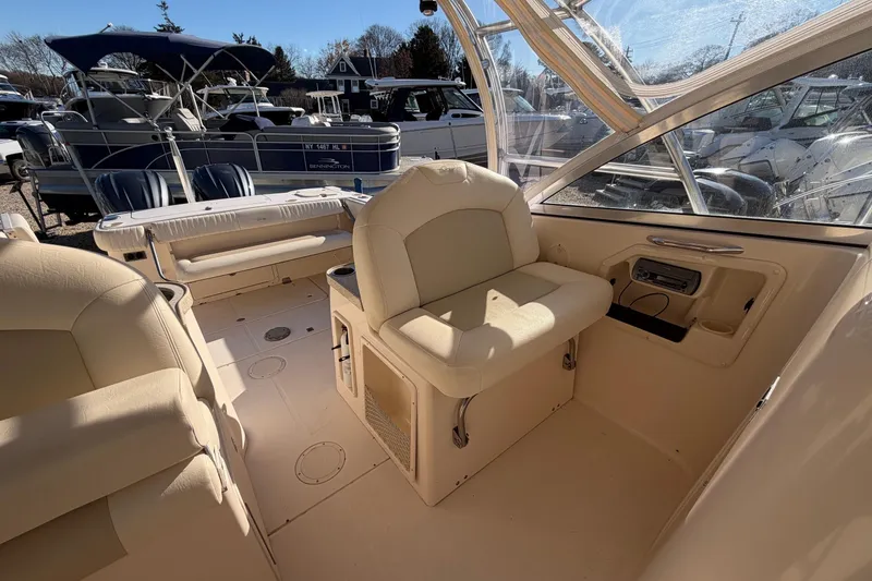Slide: The Image of 2009 Grady-White Tournament 307 boat interior with beige seating and dashboard. - 23