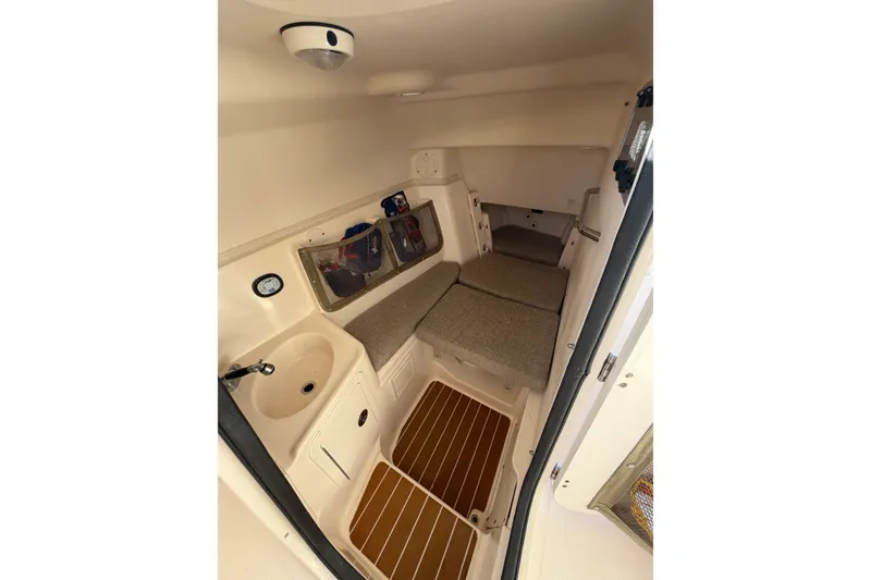 Slide: The Image of 2009 Grady-White Tournament 307 cabin interior with sink and seating area. - 24