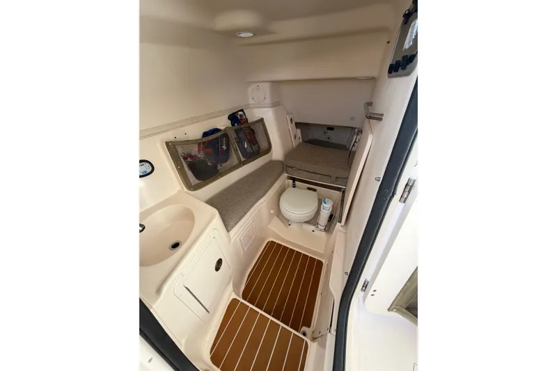 Slide: The Image of 2009 Grady-White Tournament 307 cabin interior with sink, toilet, and storage. - 25