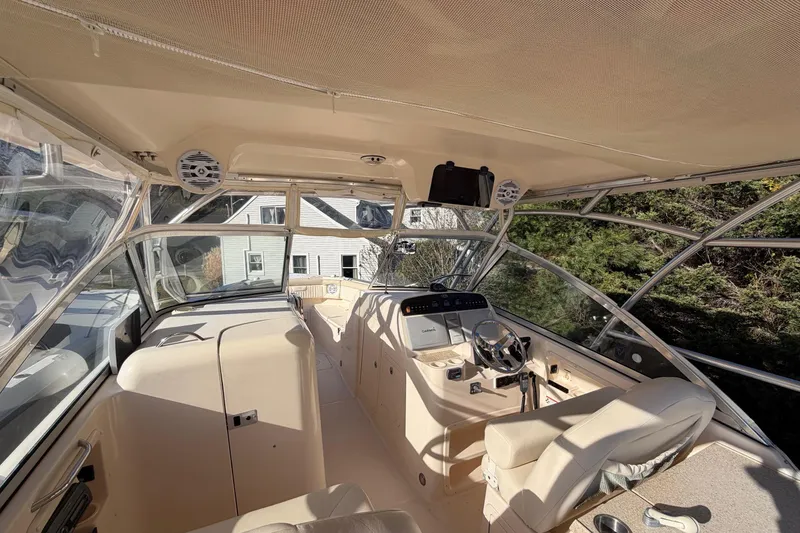 Slide: The Image of 2009 Grady-White Tournament 307 boat interior with helm, seating, and canopy. - 26