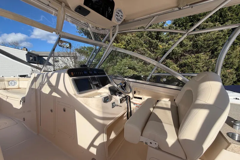 Slide: The Image of 2009 Grady-White Tournament 307 boat interior with helm and seating area. - 27
