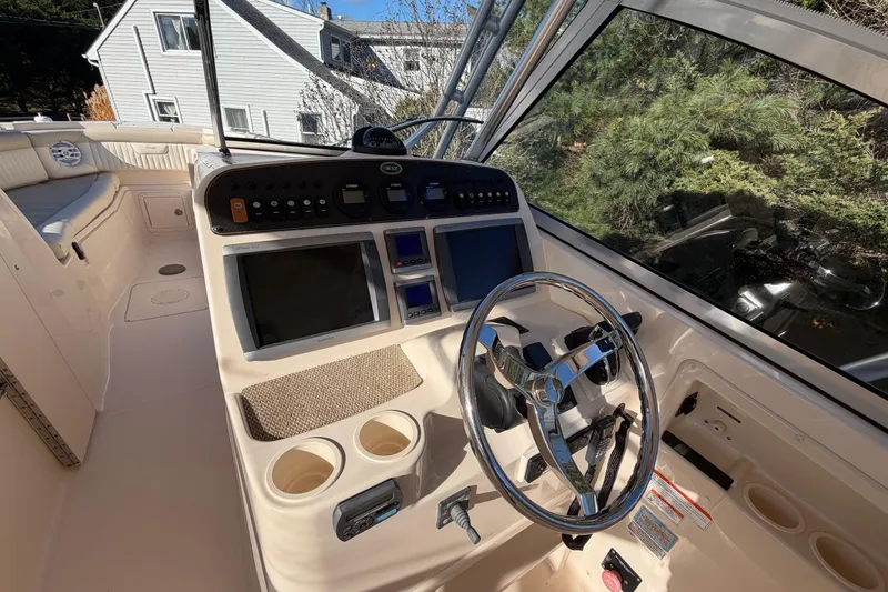 Slide: The Image of 2009 Grady-White Tournament 307 boat cockpit with steering wheel and control panel. - 29