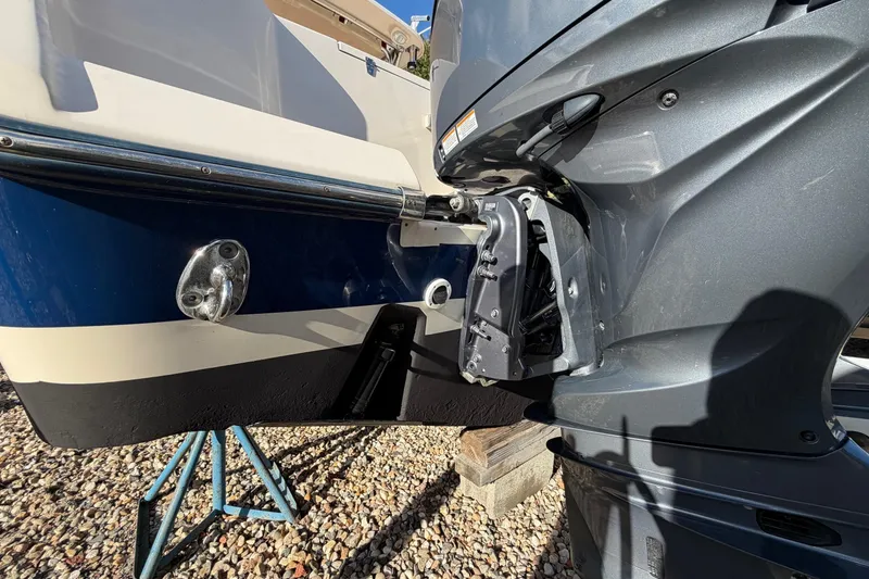 Slide: The Image of 2009 Grady-White Tournament 307 boat with outboard motor, displayed on gravel. - 3