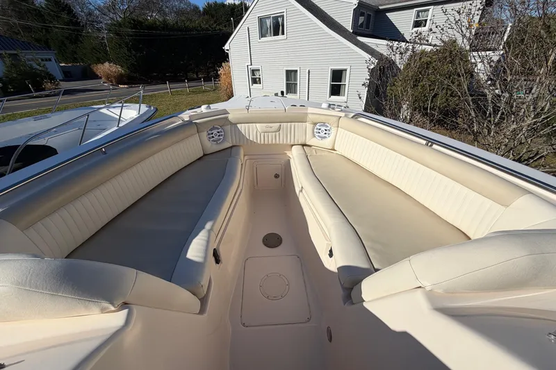 Slide: The Image of 2009 Grady-White Tournament 307 boat interior with beige seating and speakers. - 32